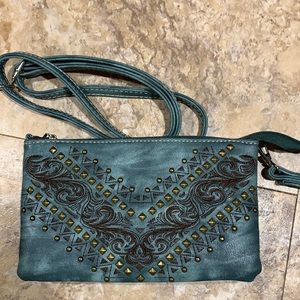 P & G leather wristlet or cross body. Has a detachable strap.